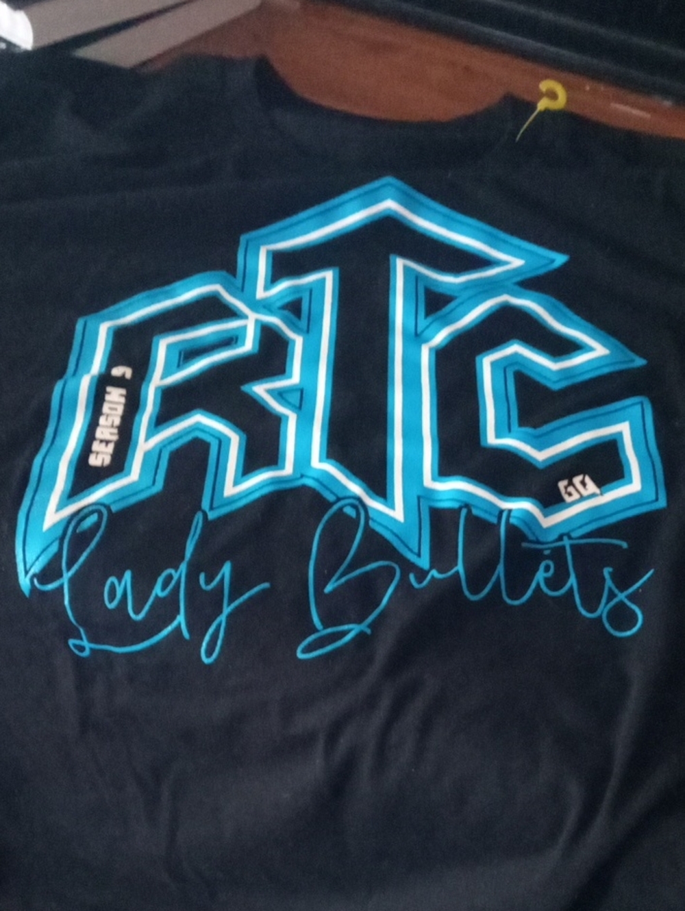 Black Graphic Tee with Blue 'Lady Bullets' Design